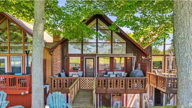 A cabin with a porch, outdoor seating, and a view of the surrounding area. - Indian Lake, Lucky 7 Chalet (Central City)