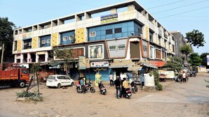 A multi-story building with a sign for Hotel Dnya Palace. - HOTEL DIVYA PALACE (Ahmedabad)