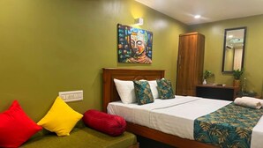 A room with a bed, a sofa, a painting, and a mirror. - Tranquil bed & breakfast with AC in Aluva (Aluva)