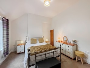 A bedroom with a bed, bedside tables, a dresser, a mirror, and a stool. - 2 bedroom accommodation in Hinton, Market Drayton. (Hinton, Market Drayton.)