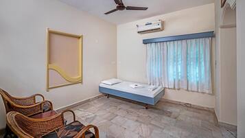 Deluxe Triple Room, Garden View | Living area | TV