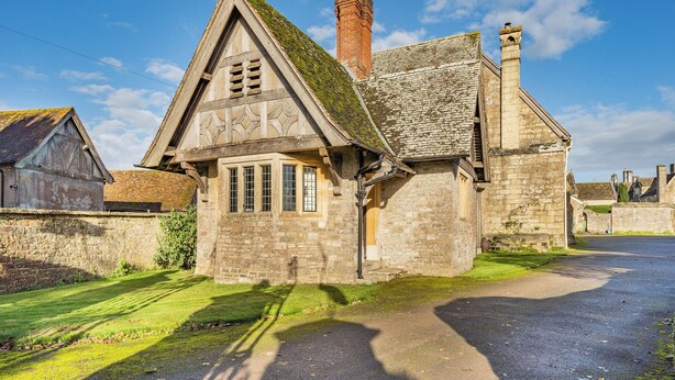A stone building with a steeply pitched roof and a chimney. - 2 bedroom accommodation in Sturminster Newton (Sturminster Newton)