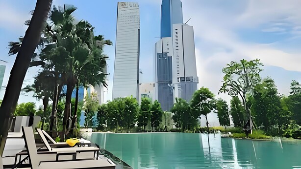 A modern building with a prominent vertical structure and a shorter adjacent building. - KLCC Agile Bukit Bintang---5 mins to TRX (Kuala Lumpur)