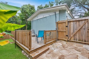 A small shed with a wooden deck, a chair, and a gate. - Hill House- Centrally Located, close to everything (Pensacola)