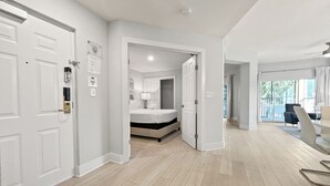 Habitación de hotel moderna con una cama grande, un escritorio y vistas al exterior.