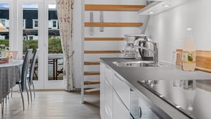 A modern kitchen with a built-in oven, a coffee maker, and a sink. - "Benthe" - 100m to the fjord by Interhome (Vestervig)