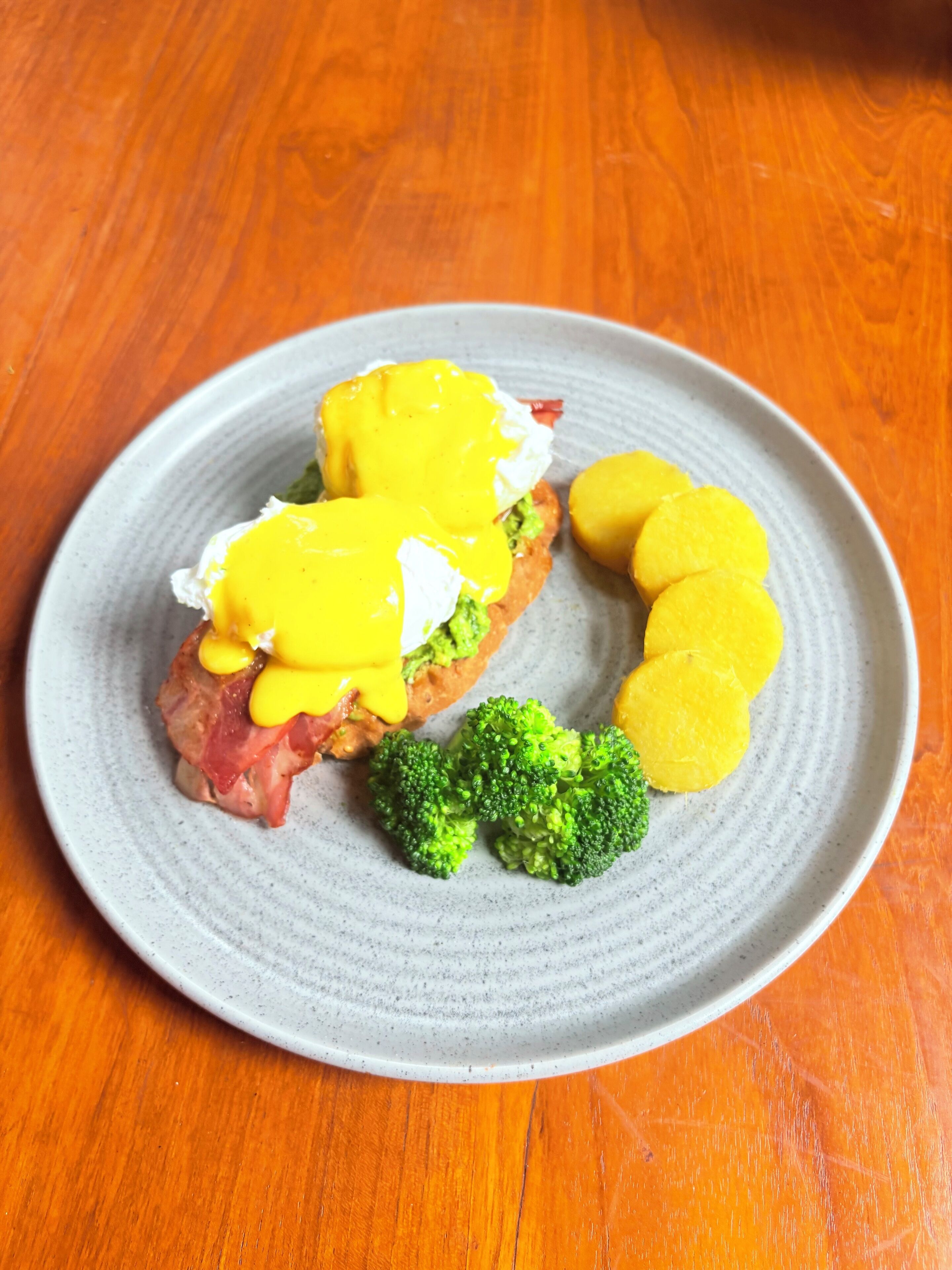 A plate with food items including eggs, meat, and broccoli.