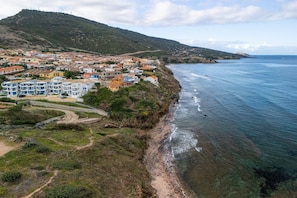 A coastal town with a mix of residential buildings and natural landscape. - 150 meters from the sea, 2 swimming pools (Valledoria)