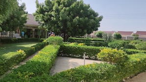 A well-maintained garden with neatly trimmed hedges and a central pathway. - The Black Gold Hotel Lokichar (Lokichar)