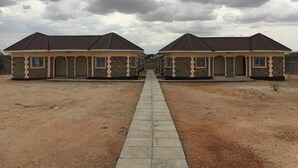 A row of identical houses with a central pathway. - The Black Gold Hotel Lokichar (Lokichar)