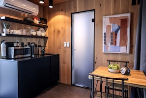 A modern kitchen with a microwave, coffee maker, and utensils on the counter. - Mirror Tiny House with Equipped Interior and Fire Pit in Orderville, Utah (Orderville)