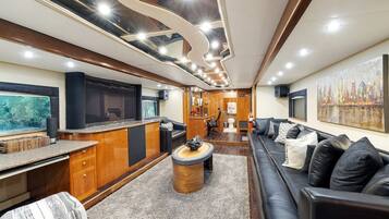 A modern interior with a living area, kitchen, and entertainment space.