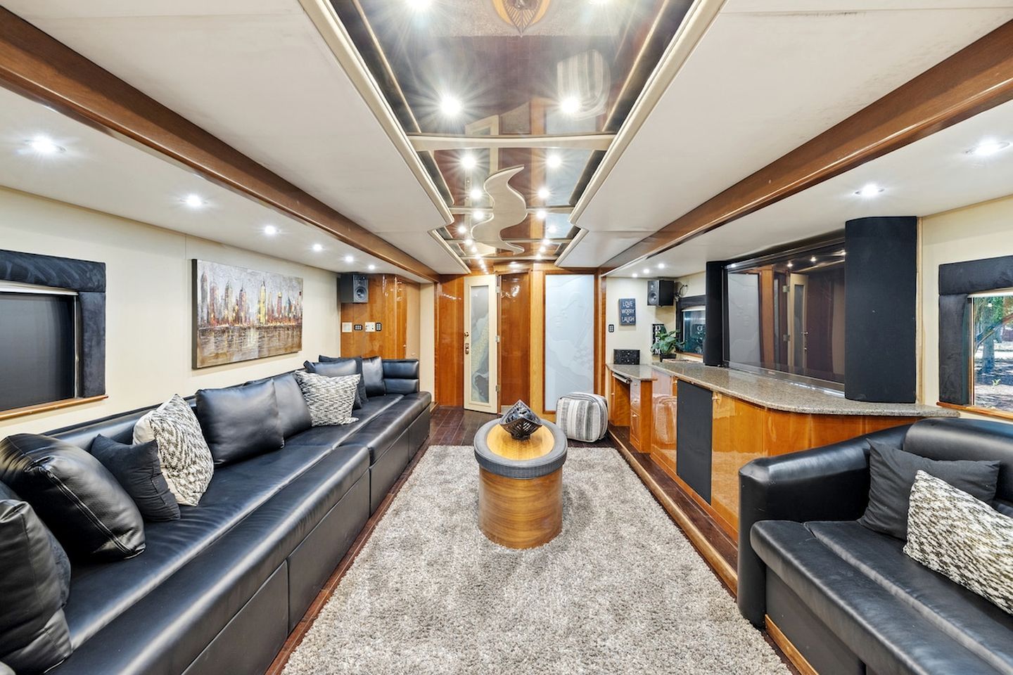 A modern interior with a sofa set, a central decorative piece, and a bar area.