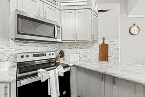 Fridge, microwave, stovetop, dining tables