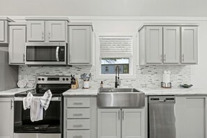 Fridge, dishwasher, coffee/tea maker, cookware/dishes/utensils