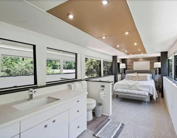 A modern bathroom with a large sink, toilet, and shower area. - Radiant Luxury Villa Retreat near Lake Walter E. Long in Texas (Austin)