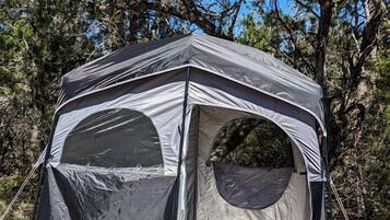 A KingCamp tent with a sleeping area and a small table.