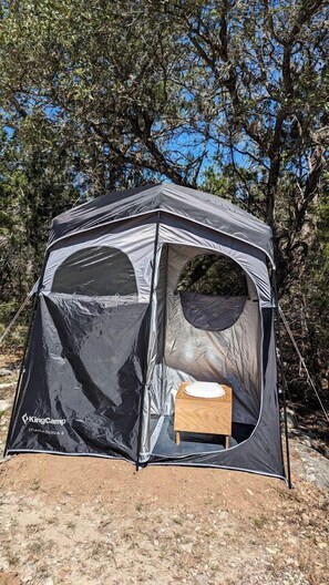 A KingCamp tent with a sleeping area and a small table.