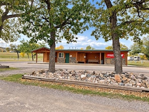 A lodge with a stone facade, wooden exterior, and a covered entrance.