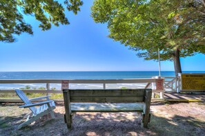 A wooden bench overlooking a beach with a clear view of the ocean. - Lovely Beach House Rental in Coastal Michigan, for Memorable Getaways to Muskegon (Muskegon)