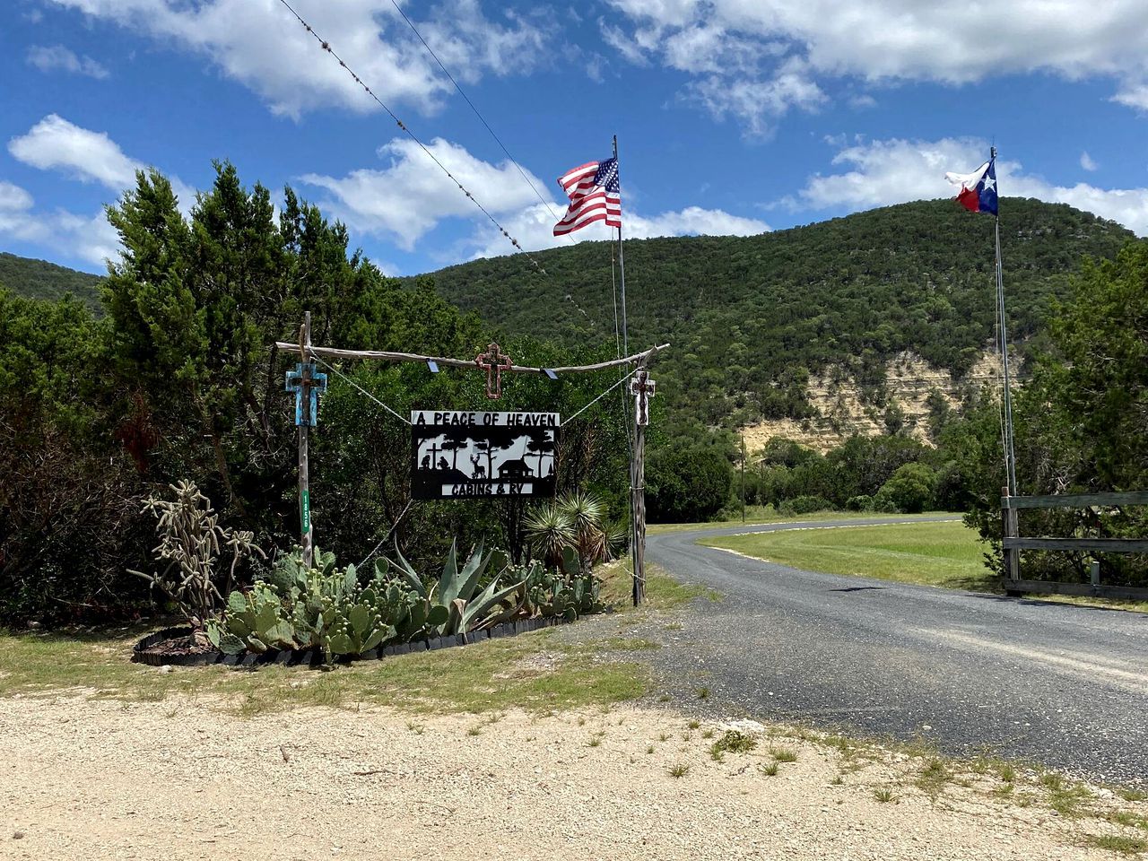 A rural road with a sign reading 'A Peace of Heaven Ranch.'