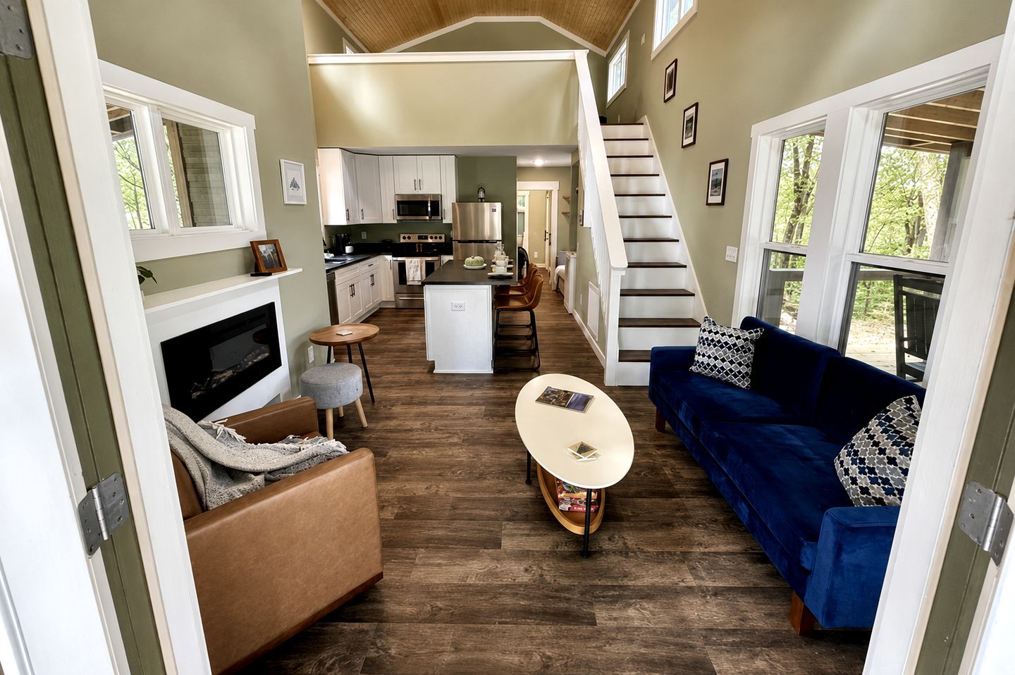 A compact living space with a kitchen, dining area, and a sofa.