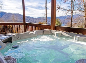 A hot tub with a view of mountains, surrounded by a wooden deck. - Lakeview Cabin with Large Private Deck in Topton, North Carolina (Topton)