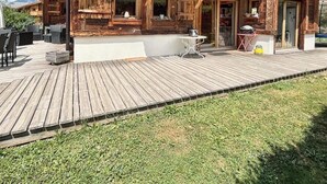 A wooden cabin with a balcony, outdoor seating, and a deck. - Luxury mountain chalet for 8 people Saint Gervais close to amenities (Saint-Gervais-les-Bains)
