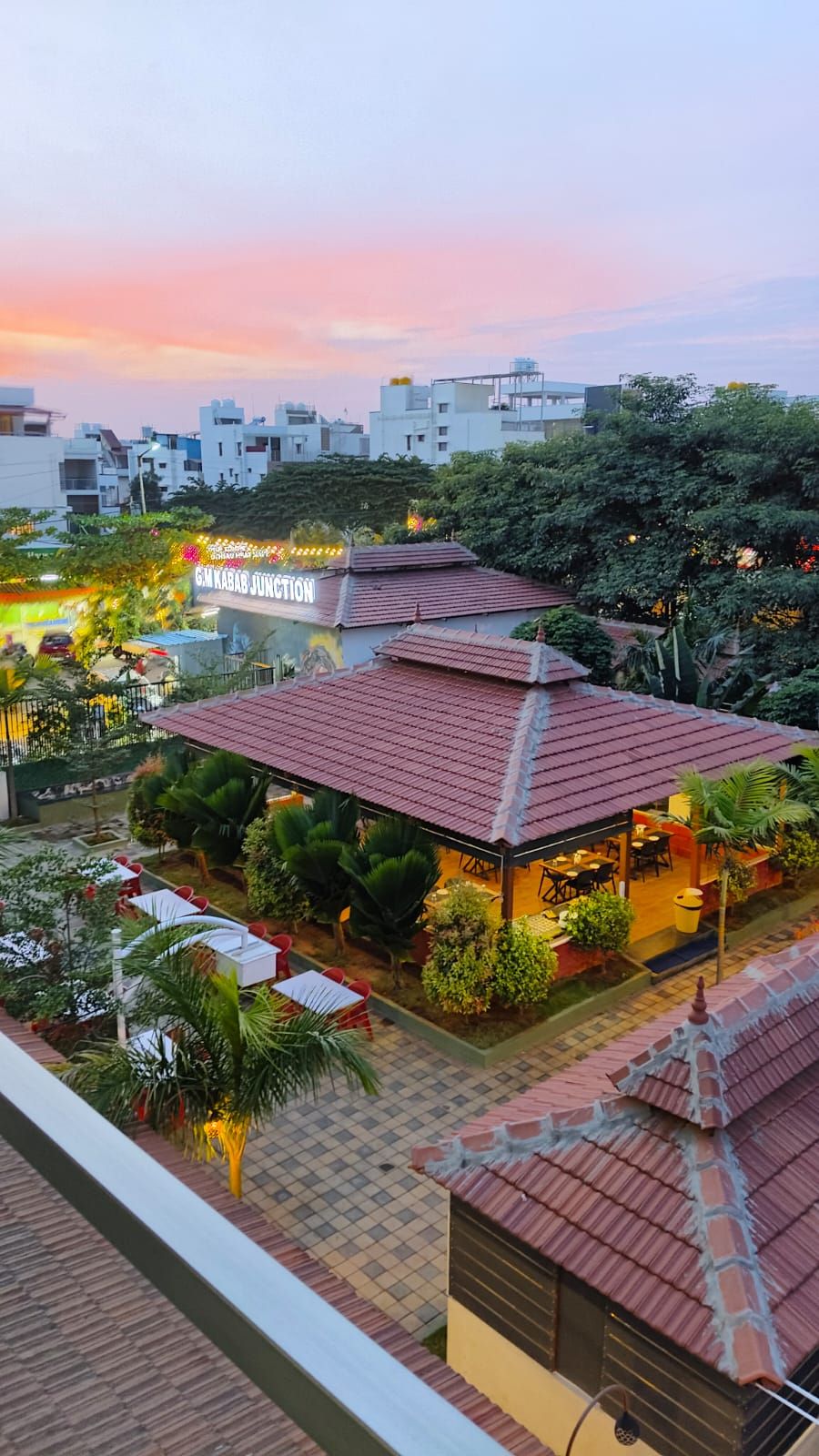 A building with a red-tiled roof and a sign reading "Gurgaon Junction".