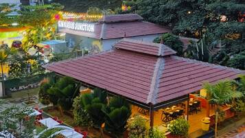 A building with a red-tiled roof and a sign reading "Gurgaon Junction".