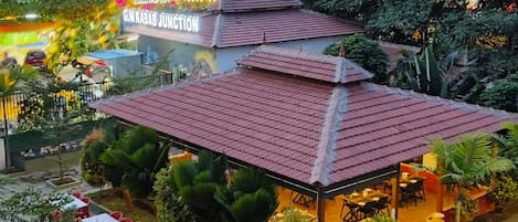 A building with a red-tiled roof and a sign reading "Gurgaon Junction".