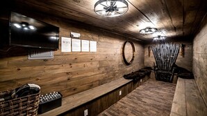 A wooden interior with a television, a sign indicating WiFi availability, and a wall-mounted mirror. - Wonderful Tiny House with Outdoor Living Areas in Alabama (Scottsboro)