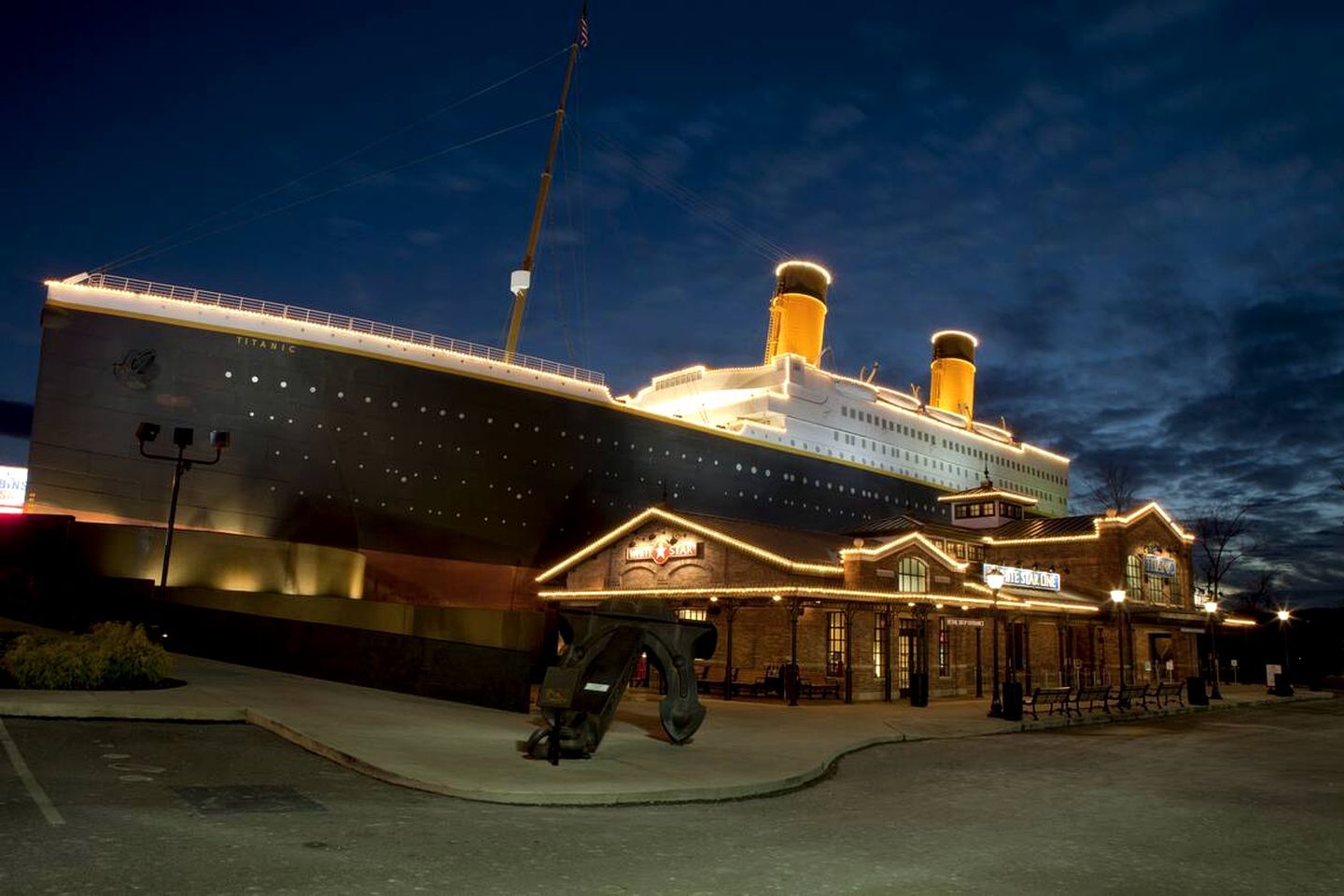 A large cruise ship docked at a port with a building labeled "The Star" in front.