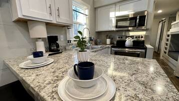 Fridge, microwave, stovetop, coffee/tea maker