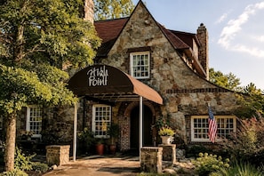 A stone building with a sign reading 'High Point' and an American flag.