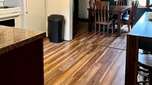 A kitchen with a refrigerator, stove, and wooden flooring. - Lakefront Cabin with Deck Great for Families in South Dakota (Hot Springs)