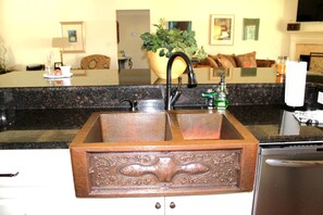 A kitchen with a double sink, granite countertop, and a dishwasher. - Outstanding Cottage with Swimming Pool in Hot Springs, Arkansas (Hot Springs)