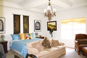 A bedroom with a bed, a sofa, a chair, a chandelier, and artwork on the walls. - Outstanding Cottage with Swimming Pool in Hot Springs, Arkansas (Hot Springs)