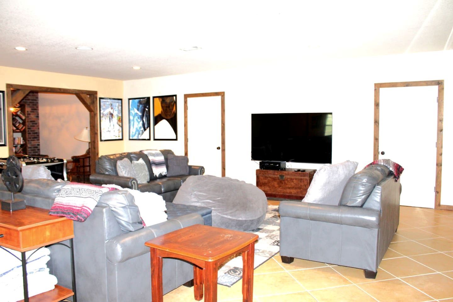 A living room with a sofa, a coffee table, a TV, and a fireplace.