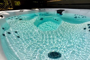 A hot tub with clear water and multiple jets. - Lofted Tiny Retreat with Private Lake Dock and Spa in Tennessee (Tracy City)