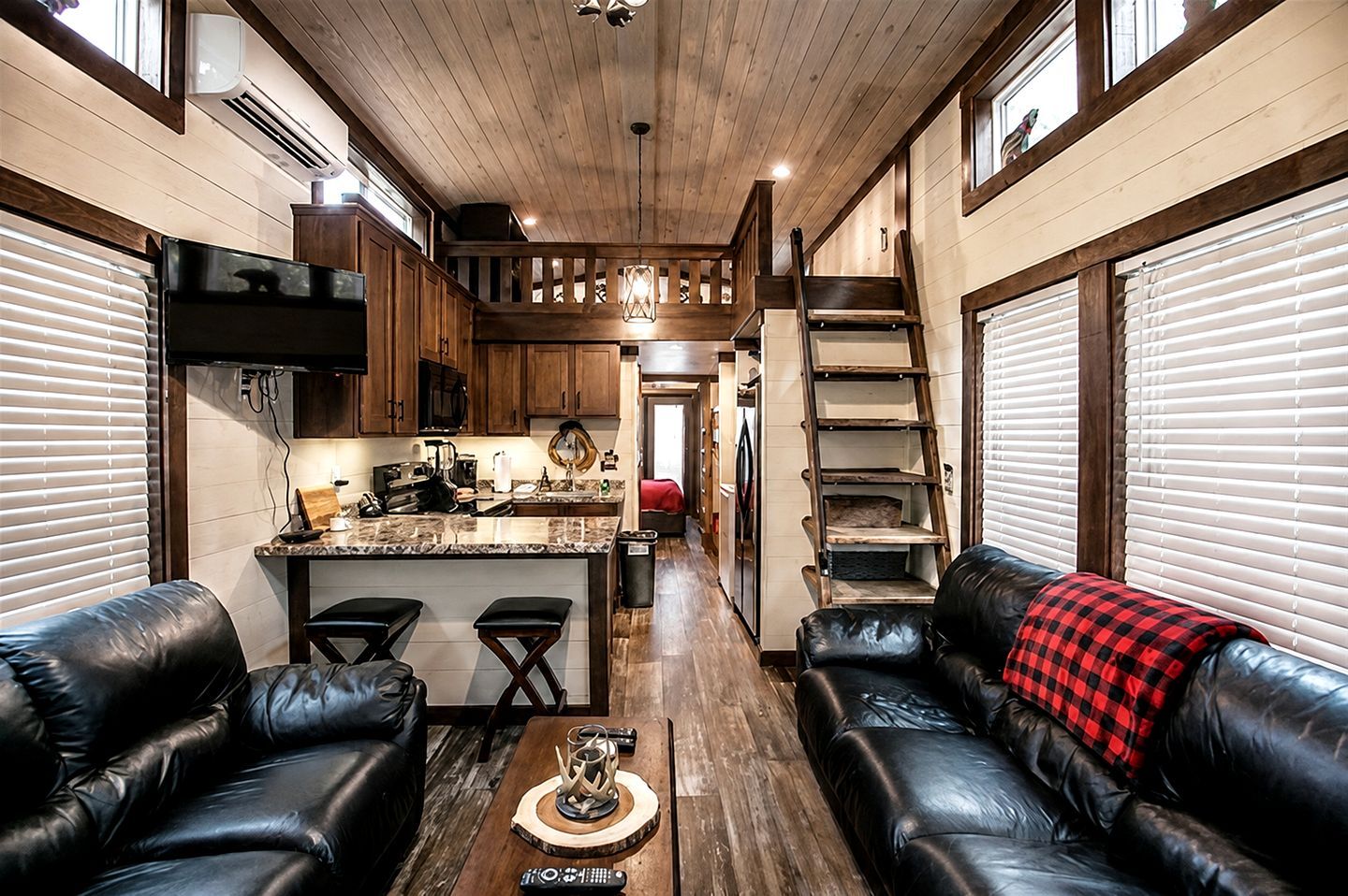 A cozy interior with a kitchen, dining area, and seating space.