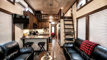 A cozy interior with a kitchen, dining area, and seating space.
