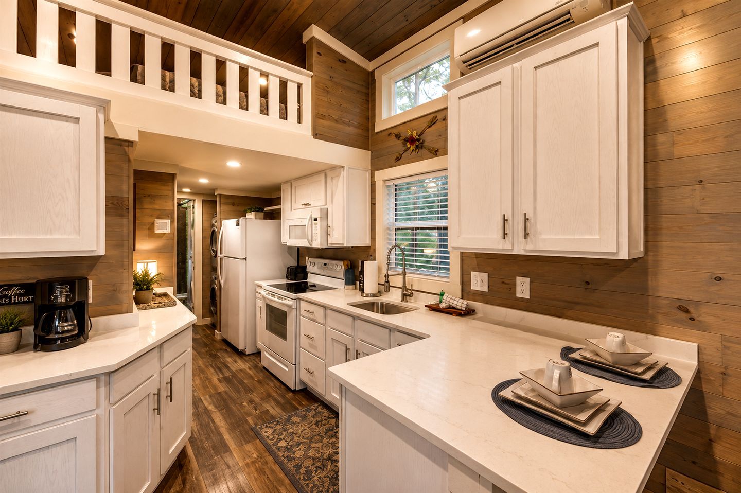 A modern kitchen with white cabinetry, a central island, and a wooden ceiling.