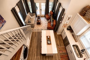 A compact living space with a kitchen, dining area, and a staircase. - Incredible Cabin with Fire Pit and Great Vistas in Monteagle, Tennessee (Monteagle)