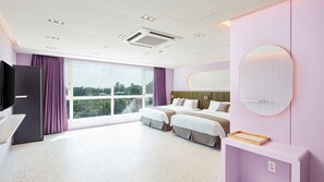 A modern hotel room with a large window, a bed, a TV, and a bathroom area. - Elren Hotel (Seogwipo)