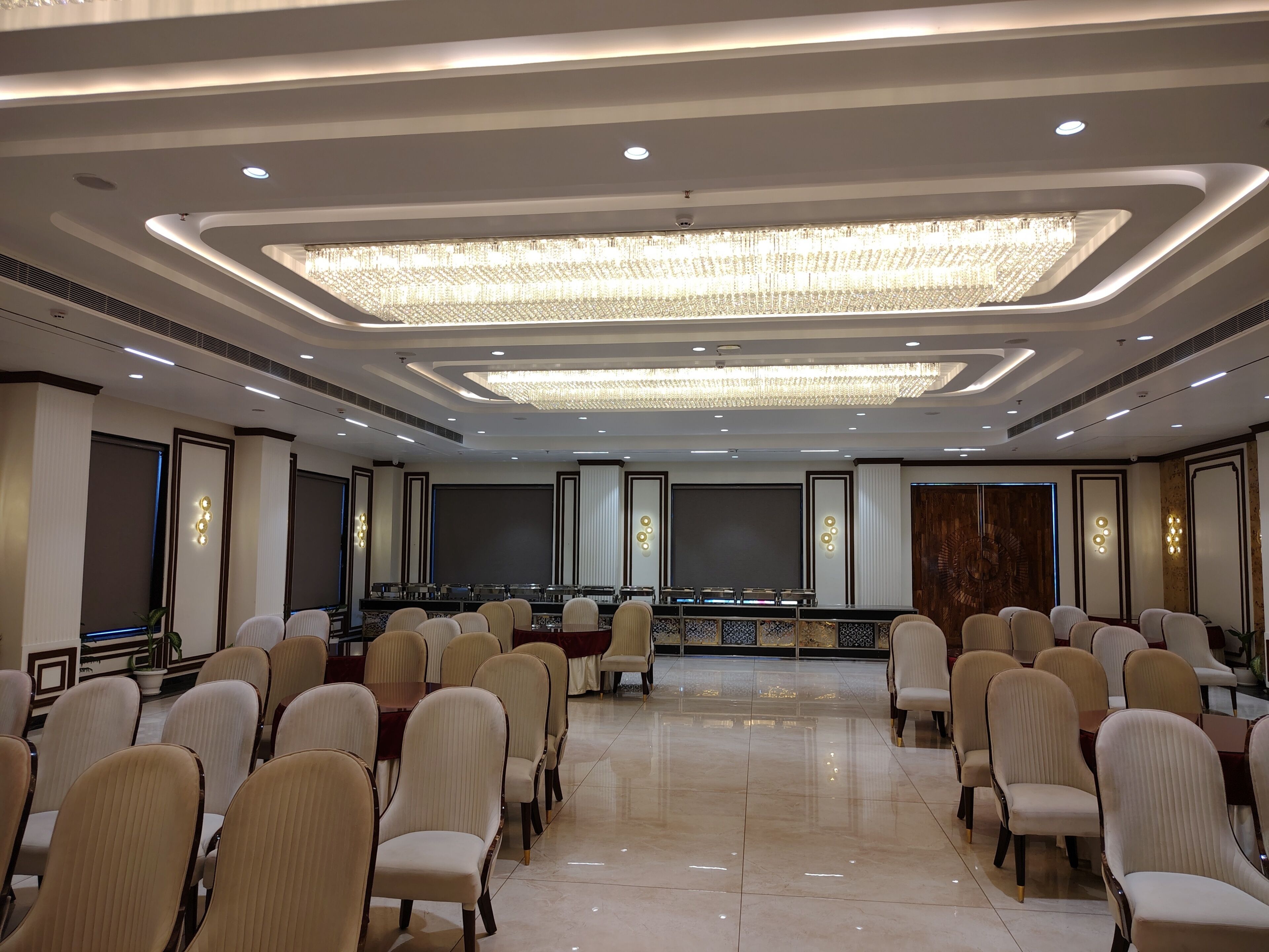 A conference room with a long table, chairs, and a chandelier.