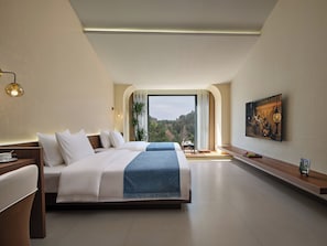 A modern hotel room with a large bed, a desk, and a painting on the wall. - Pandora Boutique Hotel-Within Zhangjiajie National Forest Park (Zhangjiajie)