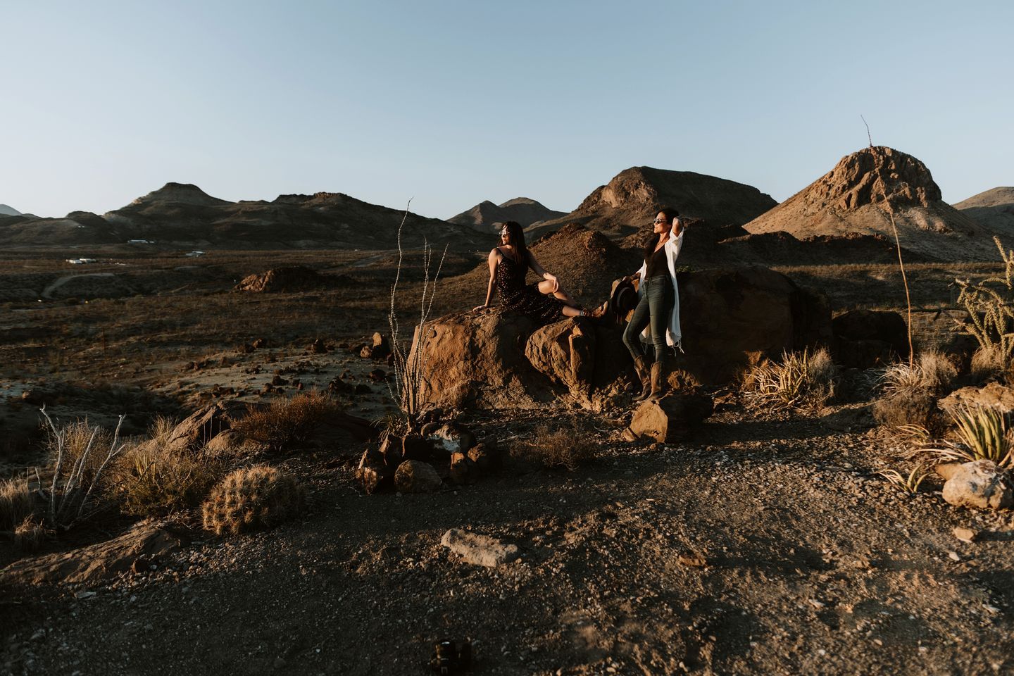 A desert landscape with rocky terrain and sparse vegetation.