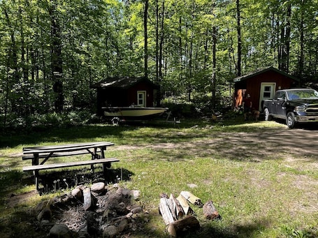 Outdoor dining. Charming Cabin in the Trees near Boulder Lake for an Amazing Escape near White Lake, Wisonsin