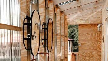 A wooden interior with a bathtub, a sink, and a door labeled 'EXIT ELEGANTLY'.